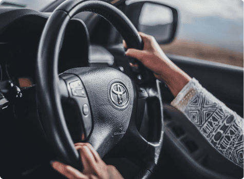 Hands on a toyota steering wheel